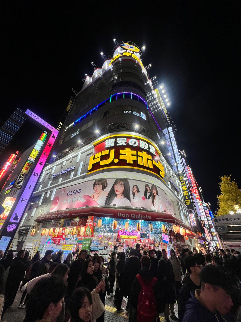 Colorful storefronts and signs glowing in Shinjuku at night
