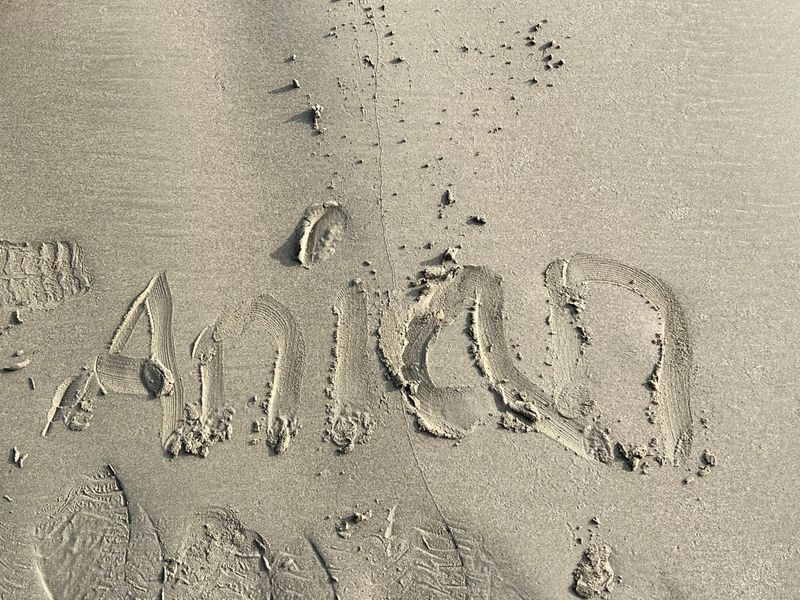 The name Anian handwritten in smooth beach sand